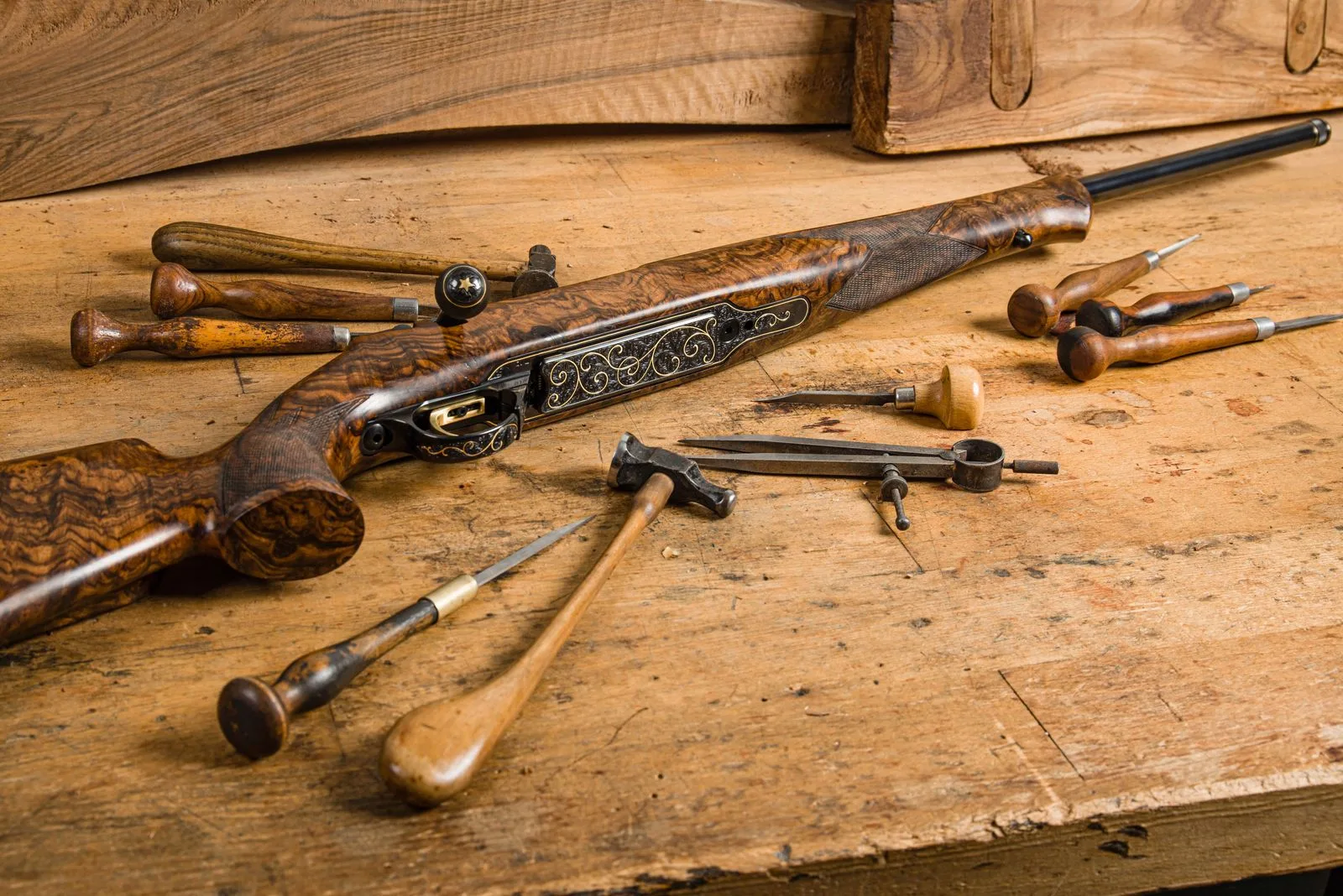 Inheriting firearms in Malta: antique rifle with engraved metalwork on a wooden workbench