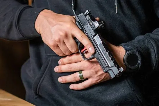 firearm in hand pointing down safely
