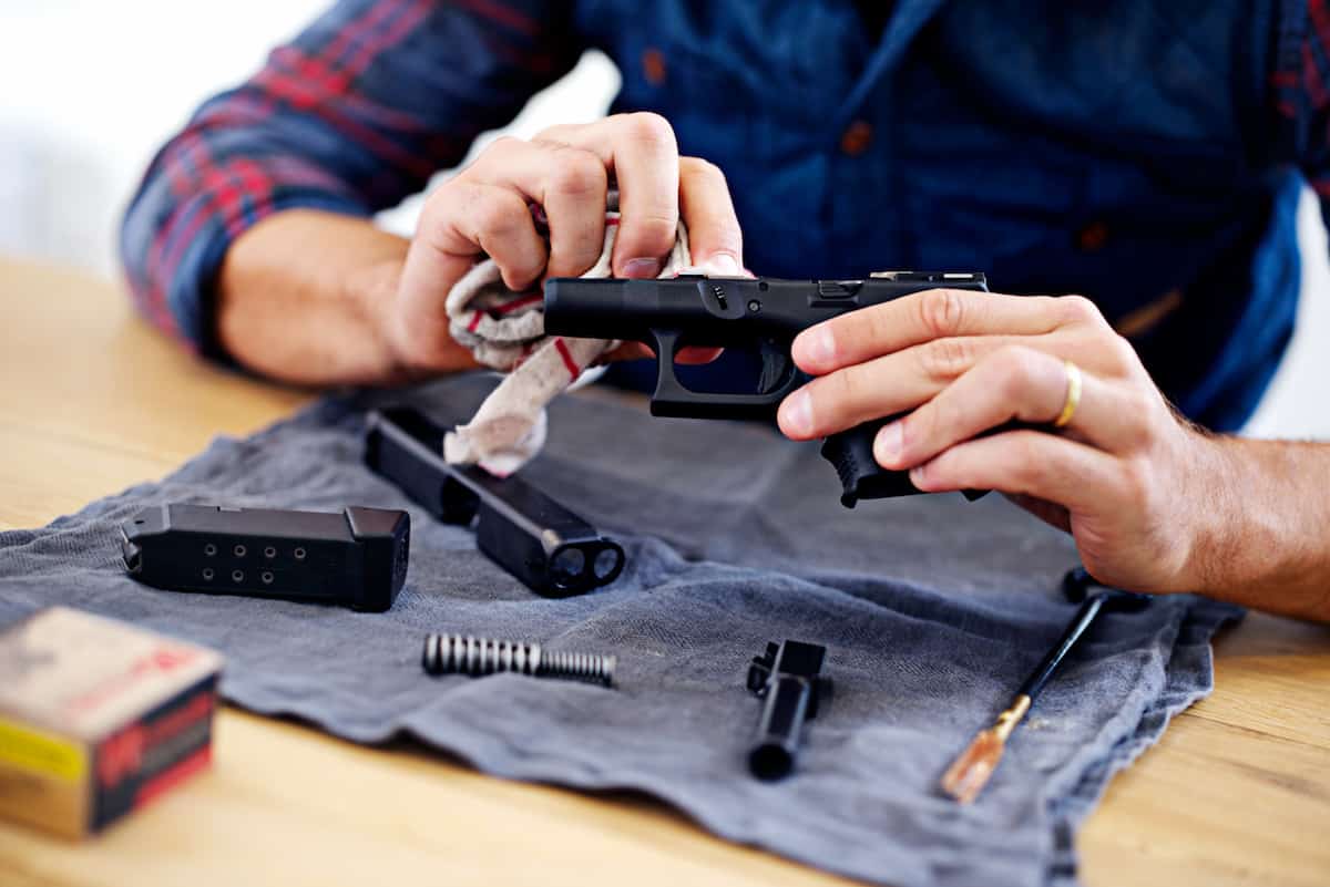 person cleaning gun